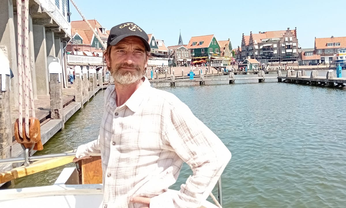 The skipper at the helm, in the harbour at Volendam