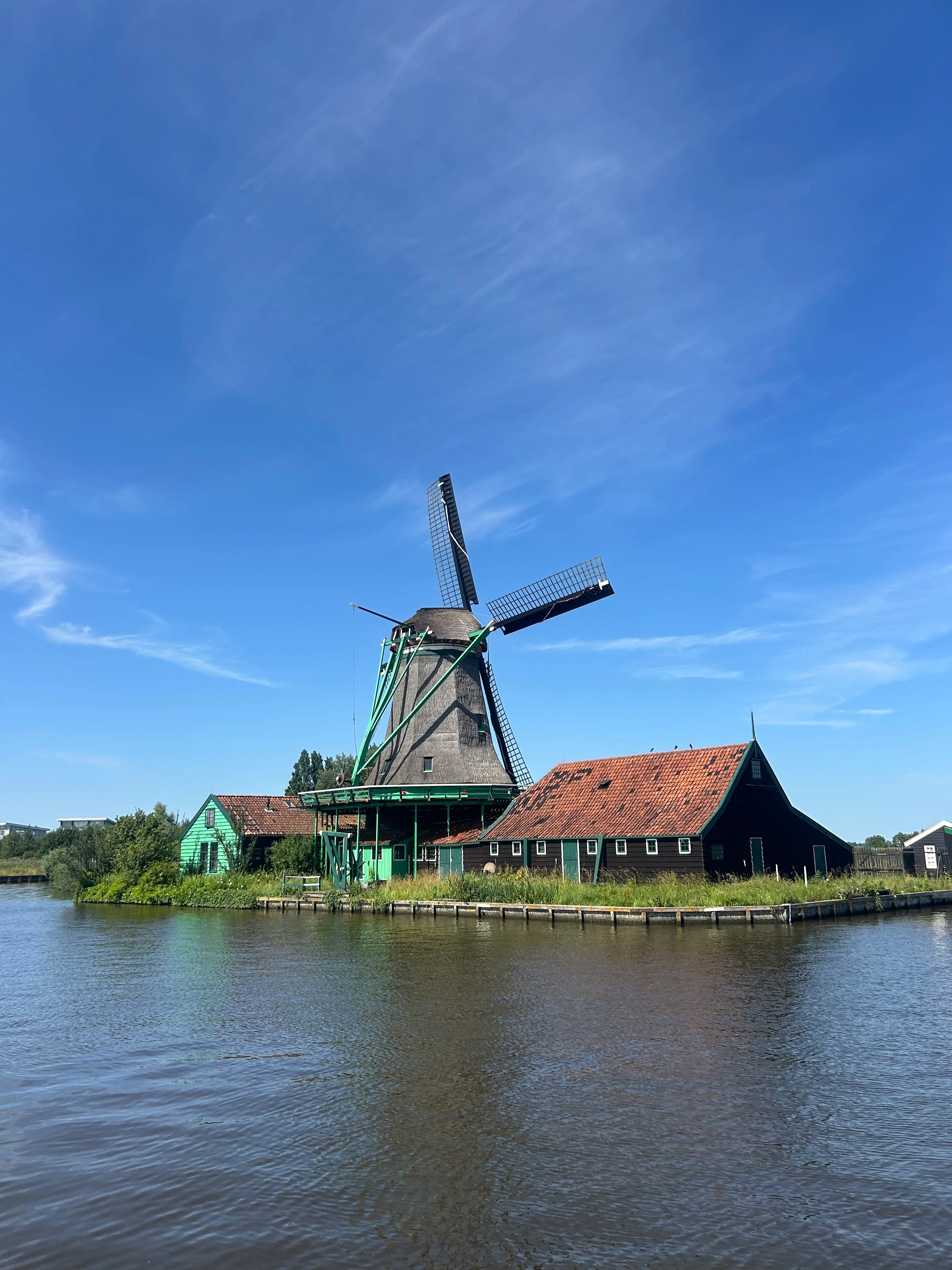 A working windmill at the Zaanse Schans, seen from the water
